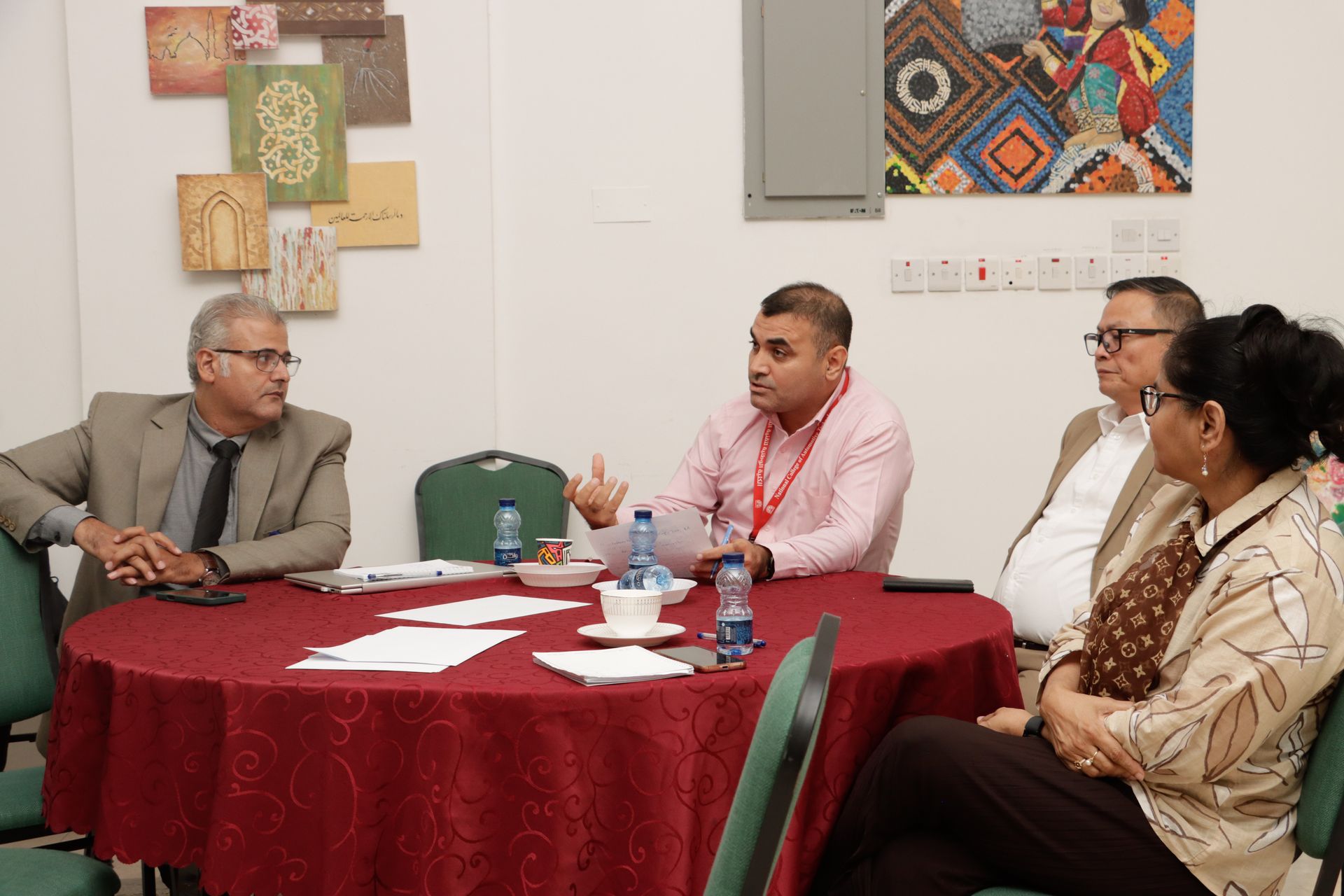 Members gathered around discussion tables at the OAQHE consultative session